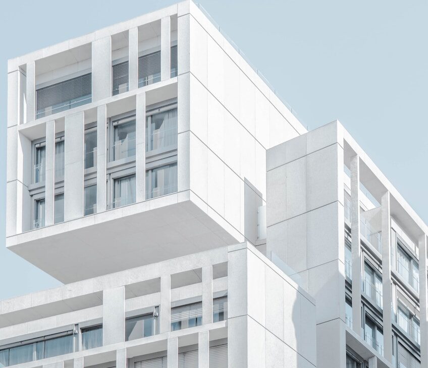 white modern cement building under blue sky